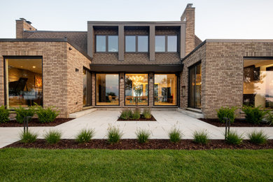 Example of a mid-sized transitional backyard concrete paver patio design in Other with no cover