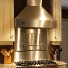 Stainless steel backsplash above range