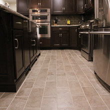kitchen- gray floor dark recessed cabinets