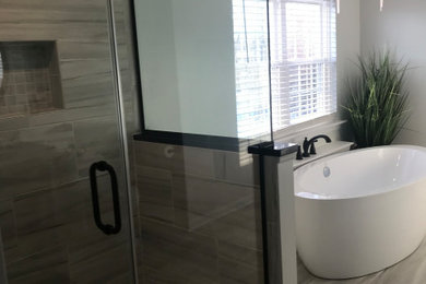 Mid-sized minimalist master white tile and porcelain tile porcelain tile and gray floor corner shower photo in DC Metro with gray walls, a hinged shower door and white countertops