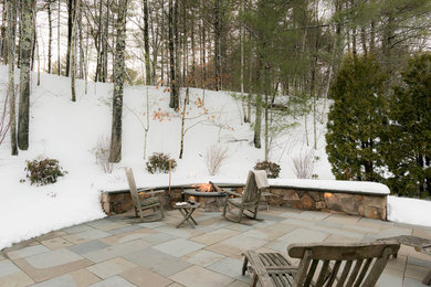 Country backyard patio in Boston with a fire feature, natural stone pavers and no cover.