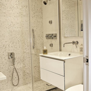 Bathroom - small contemporary master white tile and marble tile bathroom idea in New York with glass-front cabinets, white cabinets and glass countertops