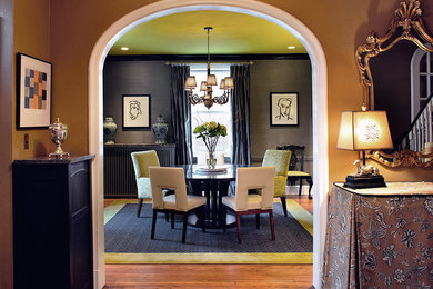 Example of a mid-sized trendy medium tone wood floor and brown floor enclosed dining room design in Orlando with gray walls and no fireplace