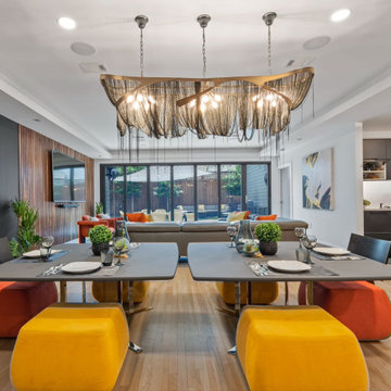 Open dining lounge beneath layered pendant lighting