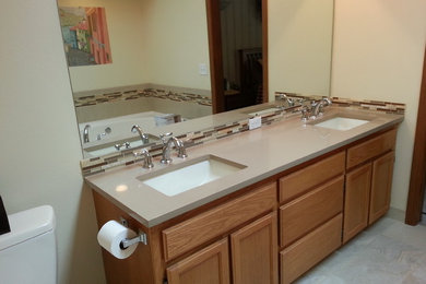 Inspiration for a mid-sized modern master beige tile and glass tile porcelain tile corner shower remodel in Seattle with an undermount sink, quartz countertops, a two-piece toilet and beige walls