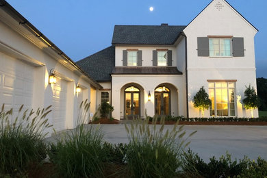 Inspiration for a large transitional white two-story brick exterior home remodel in Other