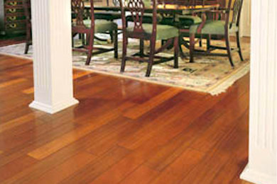 Example of a large classic medium tone wood floor and brown floor enclosed dining room design in Phoenix with beige walls and no fireplace
