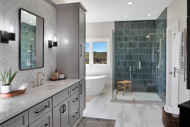 Design ideas for a large transitional master bathroom in Denver with recessed-panel cabinets, grey cabinets, a freestanding tub, an open shower, a one-piece toilet, green tile, cement tile, white walls, porcelain floors, an undermount sink, engineered quartz benchtops, white floor, a hinged shower door, white benchtops, a niche, a double vanity and a built-in vanity.