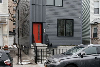 Example of a small minimalist gray two-story exterior home design in New York