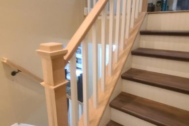 Example of a mid-sized beach style wooden l-shaped wood railing staircase design in New York with wooden risers