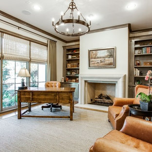 This is an example of a large traditional study room in Dallas with white walls, carpet, a standard fireplace, a stone fireplace surround, a freestanding desk and grey floor.