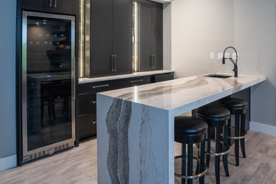 Design ideas for a mid-sized contemporary single-wall wet bar in Other with an undermount sink, black cabinets, quartz benchtops, vinyl floors, grey floor and multi-coloured benchtop.