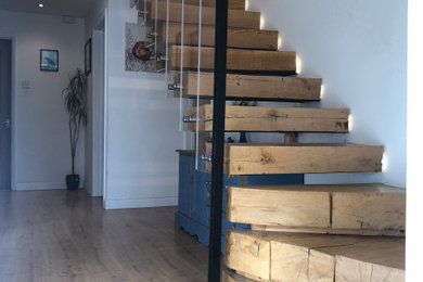 Design ideas for a modern wood floating glass railing staircase in Other with wood risers.