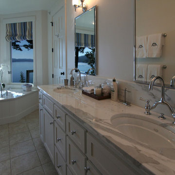 predominately white Master bathroom with lake views