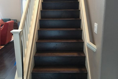 Large arts and crafts wood staircase in San Francisco with wood risers and wood railing.
