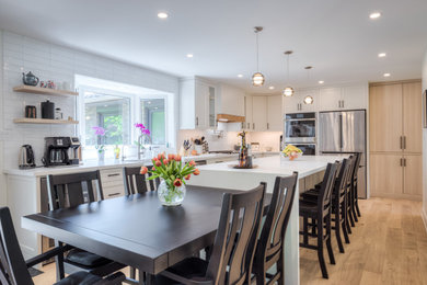 Mid-sized trendy light wood floor and beige floor kitchen/dining room combo photo in Toronto with white walls