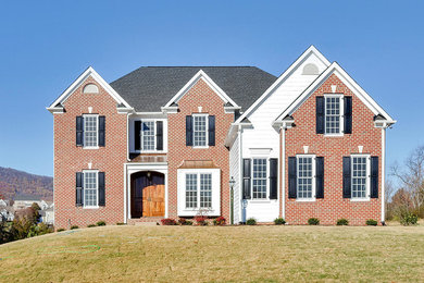 Inspiration for a large timeless red two-story brick exterior home remodel in DC Metro