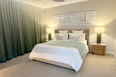 Photo of a large contemporary master bedroom in Brisbane with grey walls, carpet and grey floor.