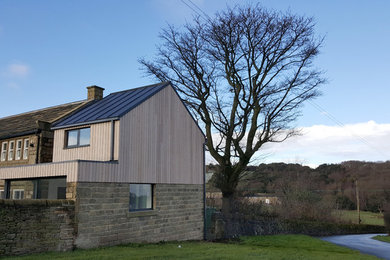 Inspiration for a large contemporary two floor detached house in Other with wood cladding, a pitched roof and a metal roof.