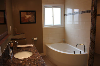 Bathroom - mid-sized transitional beige tile and ceramic tile porcelain tile bathroom idea in Toronto with raised-panel cabinets, medium tone wood cabinets, a two-piece toilet, brown walls, an undermount sink and marble countertops