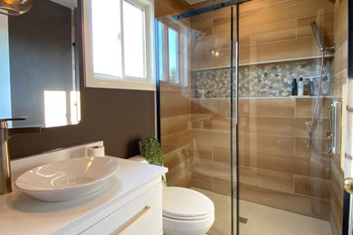Bathroom - small contemporary master brown tile and wood-look tile porcelain tile, beige floor and single-sink bathroom idea in Toronto with flat-panel cabinets, white cabinets, a two-piece toilet, brown walls, a vessel sink, quartz countertops, white countertops and a floating vanity