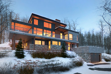 Design ideas for a contemporary three-storey grey exterior in Montreal with wood siding.