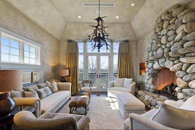 Mid-sized mountain style formal and enclosed medium tone wood floor and brown floor living room photo in New York with beige walls, a standard fireplace, a stone fireplace and no tv