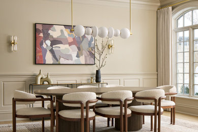 Inspiration for a large timeless light wood floor, brown floor and wainscoting enclosed dining room remodel in Chicago with beige walls