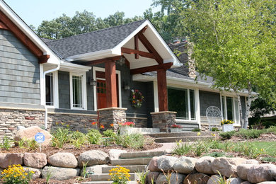Example of a large transitional gray one-story mixed siding gable roof design in Minneapolis