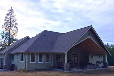 Inspiration for a large craftsman backyard concrete patio remodel in Seattle with a roof extension