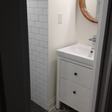 Small bathroom in a basement with low ceiling
