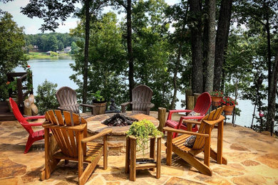 Mid-sized elegant backyard stone patio photo in Birmingham with a fire pit