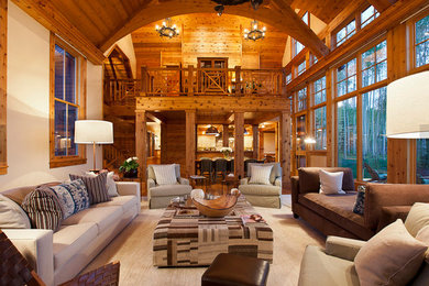 Example of a large mountain style formal and open concept medium tone wood floor and brown floor living room design in Denver with beige walls, no fireplace and no tv