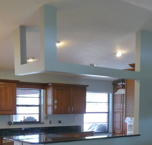 Decorations On A Suspended Shelf Between A Kitchen And Living Room