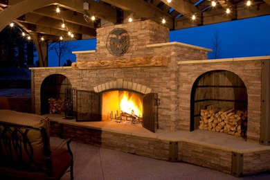 Example of a large transitional backyard concrete paver patio design in Denver with a fire pit and a pergola