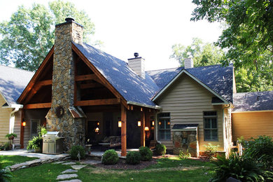 Patio - large traditional backyard concrete paver patio idea in Other with a fire pit and a roof extension