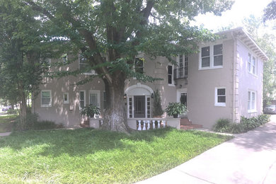 Mid-sized elegant beige two-story brick exterior home photo in Houston with a hip roof