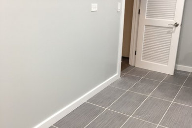 Utility room - mid-sized modern galley ceramic tile utility room idea in Chicago with an utility sink, gray walls and a side-by-side washer/dryer