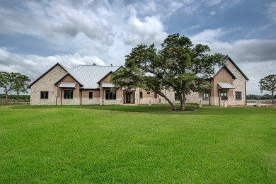 Example of a classic white stone exterior home design in Houston