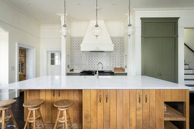 Medium sized traditional kitchen in Berkshire with an integrated sink, medium wood cabinets, quartz worktops, black appliances, dark hardwood flooring, an island and white worktops.