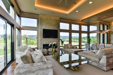 Design ideas for a mid-sized contemporary open concept family room in Denver with a ribbon fireplace, a stone fireplace surround, beige walls, a wall-mounted tv, dark hardwood floors and brown floor.