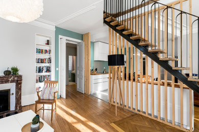 This is an example of a mid-sized transitional wood l-shaped staircase in Clermont-Ferrand with open risers.