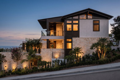 Inspiration for a huge contemporary white three-story wood exterior home remodel with a metal roof