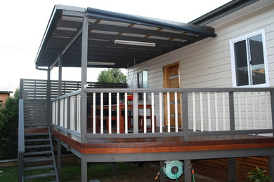 Design ideas for a small contemporary backyard deck in Newcastle - Maitland with a roof extension.