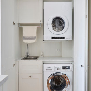 Inspiration for a medium sized farmhouse laundry cupboard in Melbourne with shaker cabinets, white cabinets, marble worktops, a built-in sink, white walls and medium hardwood flooring.