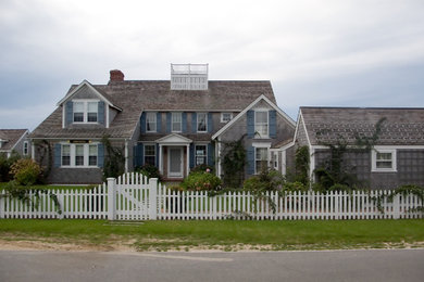 Example of a mid-sized trendy gray two-story wood exterior home design in Boston
