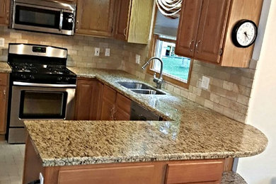 Example of a mid-sized classic u-shaped kitchen design in New York with an undermount sink, multicolored backsplash, stone tile backsplash and no island