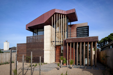 Contemporary two-storey brown exterior in Melbourne with wood siding.
