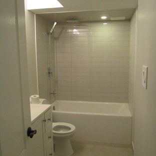 Design ideas for a small modern fully buried basement in Toronto with grey walls, carpet, a hanging fireplace, a stone fireplace surround and grey floors.