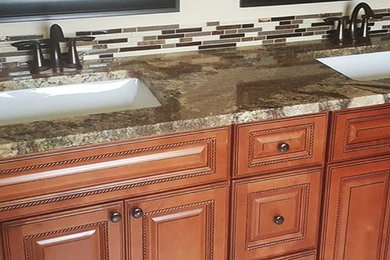 Drop-in bathtub - large contemporary master beige tile medium tone wood floor and brown floor drop-in bathtub idea in Denver with raised-panel cabinets, medium tone wood cabinets, beige walls, an undermount sink and quartzite countertops